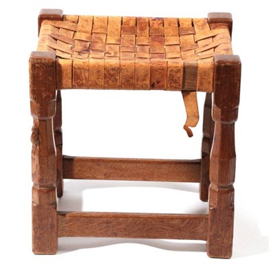 Lot 612 - Mouseman: A Robert Thompson of Kilburn English Oak Stool, strap leather top, on four octagonal legs