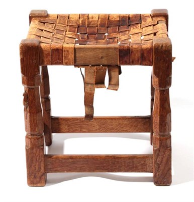 Lot 615 - Mouseman: A Robert Thompson of Kilburn English Oak Stool, strap leather top, on four octagonal legs