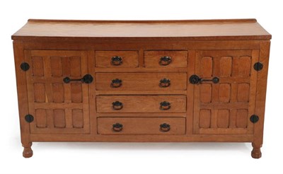 Lot 629 - A Sid Pollard of Thirsk English Oak Panelled Sideboard, with raised upstand, above two cupboard...