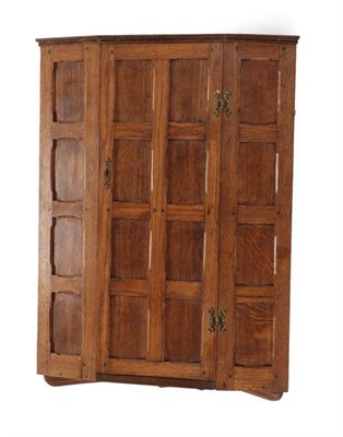 Lot 633 - A Sid Pollard of Thirsk English Oak Hanging Corner Cupboard, the panelled door opening to...