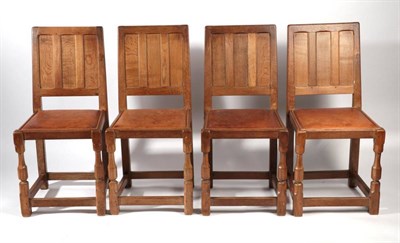 Lot 634 - Sid Pollard of Thirsk: A Set of Four English Oak Panel Back Dining Chairs, leather seats, on...