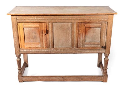 Lot 643 - A 1920's Limed Oak Sideboard, the rectangular top above a central panel enclosed by two...