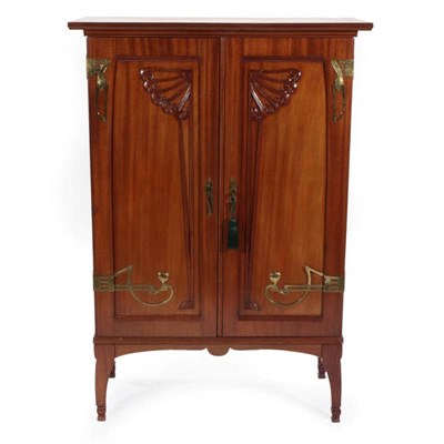 Lot 645 - An Art Nouveau French Walnut Double Door Cabinet, with stylised brass hinges and lock plates,...