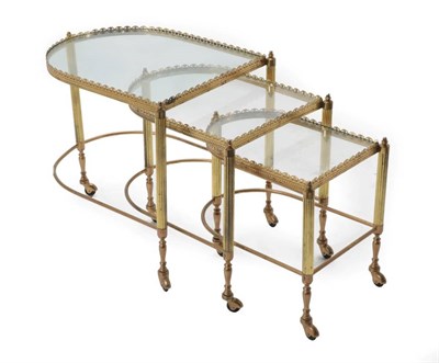 Lot 682 - A Set of Three Brass and Glass Top Nesting Tables, late 20th century, in the form of a trolley,...