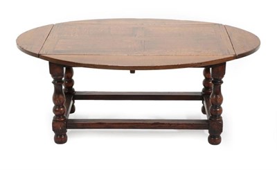 Lot 688 - A Titchmarsh & Goodwin Reproduction Oak Dropleaf Coffee Table, with pivoting top to form a...