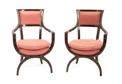 Lot 709 - A Pair of Mahogany and Parcel Gilt Cross-Frame Open Armchairs, upholstered in pink watered...