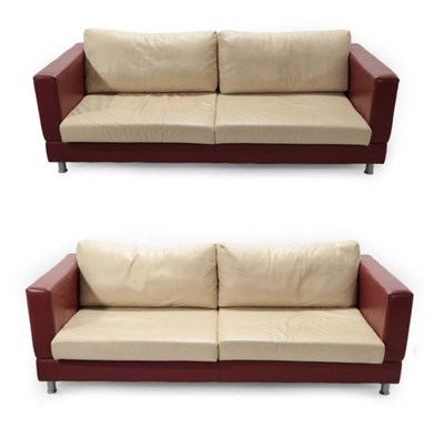 Lot 713 - A Pair of Three-Seater Sofas, modern, covered in red leather with cream cushions, on metal...