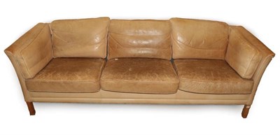 Lot 719 - A 1970's Light Tan Leather Three-Seater Sofa, with slender arms above stained brown square form...