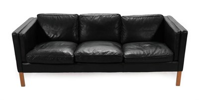 Lot 724 - A 1970's Danish Stouby Three-Seater Sofa, upholstered in black leather, with eight cushions,...