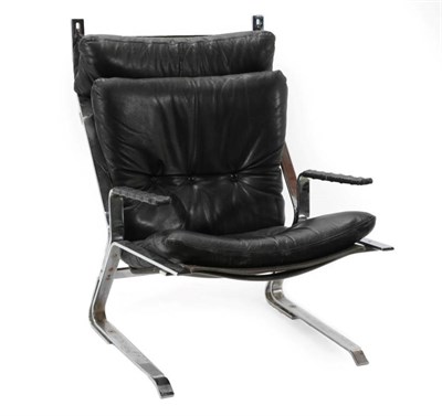 Lot 734 - A 1970's Black Leather Armchair, with buttoned seat and back support, with a polished metal...