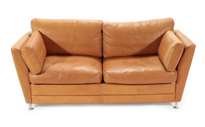 Lot 754 - A 1970's Danish Stouby Two-Seater Sofa, upholstered in natural tan leather, with six cushions,...