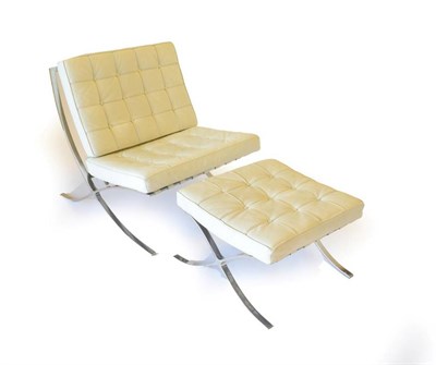 Lot 770 - A Barcelona Style Easy Chair, modern, with polished chrome frame and two buttoned cream leather...