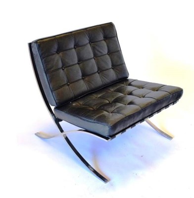 Lot 773 - A Barcelona Style Armchair, modern, with polished chrome metal frame and two black buttoned leather