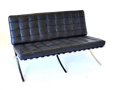 Lot 774 - A Barcelona Style Sofa, modern, with polished chrome metal frame and two black buttoned leather...