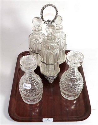 Lot 2 - Silver plated three bottle decanter stand and a pair of Georgian decanters