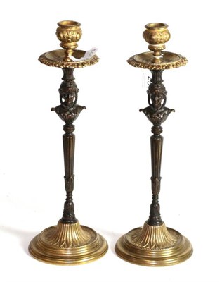 Lot 29 - A pair of French Empire bronze and gilt bronze figural candlesticks