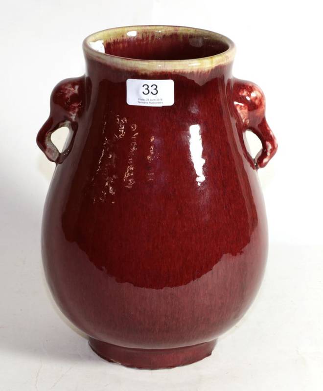 Lot 33 - A Chinese sang de boeuf baluster vase with twin handled elephantine handles, 28cm high