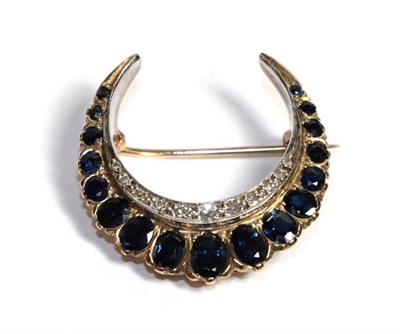 Lot 57 - A 9 carat gold diamond and sapphire crescent brooch, length 2.7cm