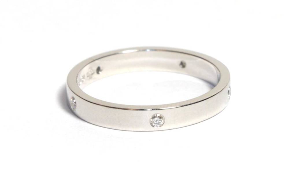 Lot 58 - A platinum diamond band ring, inset with five round brilliant cut diamonds, total estimated diamond
