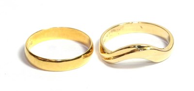 Lot 81 - A 22 carat gold band ring, finger size K' and an 18 carat gold shaped ring, finger size M (2)