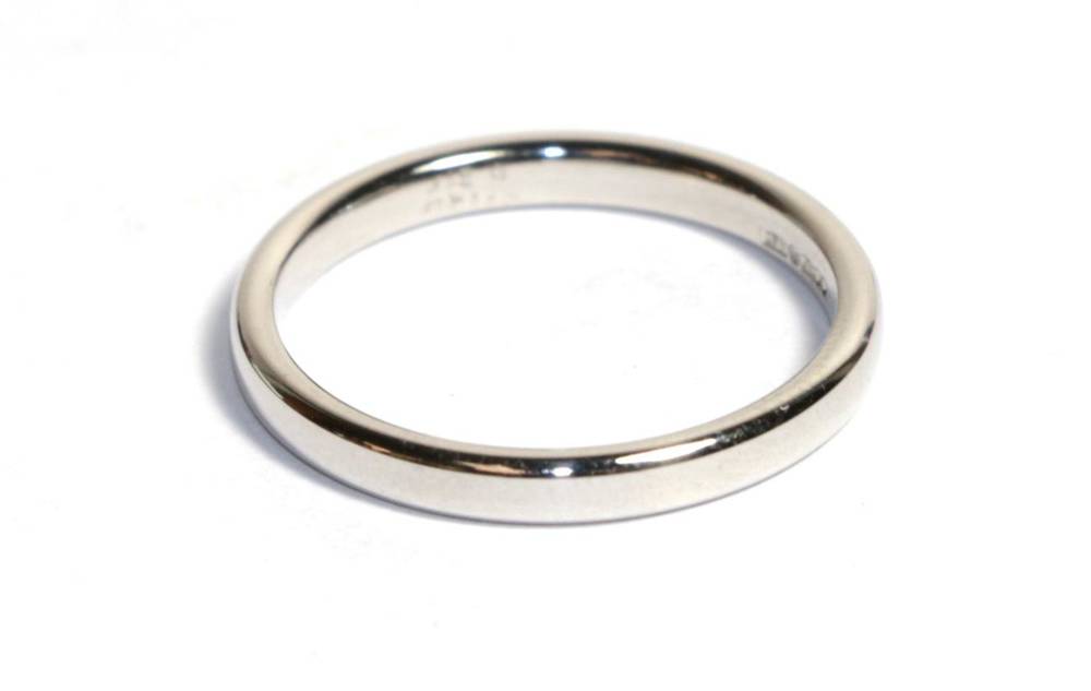 Lot 82 - A platinum band ring, finger size K