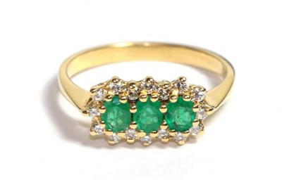 Lot 89 - An emerald and diamond cluster ring, three oval mixed cut emeralds within a border of round...