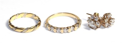 Lot 106 - An 18 carat to colour gold band ring, finger size M; and a 9 carat gold cubic zirconia ring and...