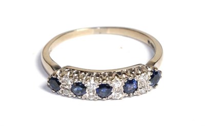 Lot 112 - An 18 carat gold diamond and sapphire half hoop ring, finger size P