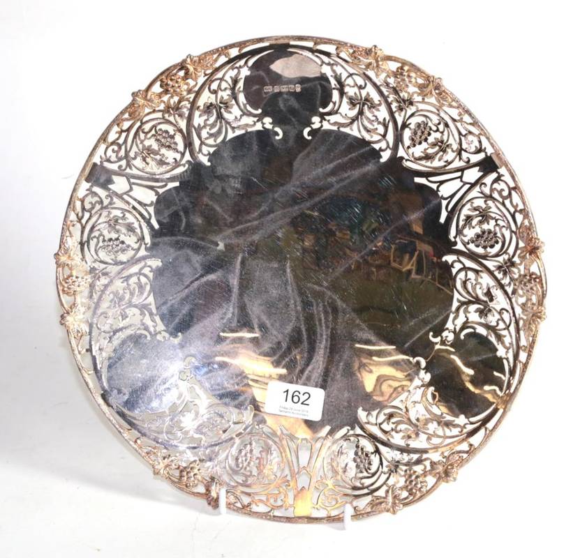 Lot 162 - A large silver dish, Camelot Silverware, Sheffield 1977, with cast fruiting vine rim and broad...