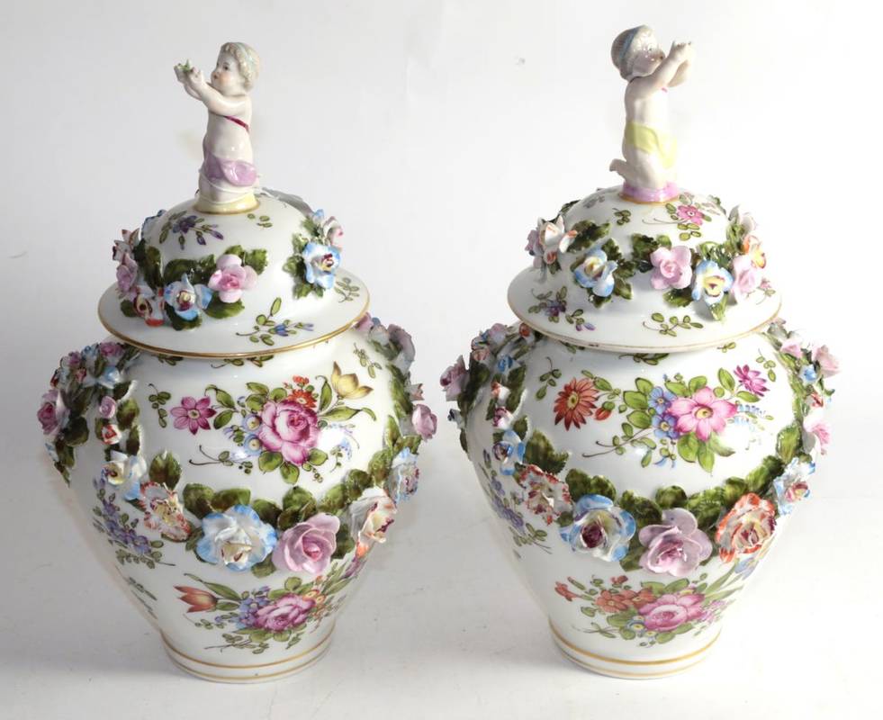 Lot 177 - A pair of Continental floral encrusted vases and covers, pseudo blue crossed sword marks