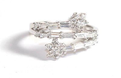 Lot 204 - An 18 carat white gold diamond floral twist ring, finger size L