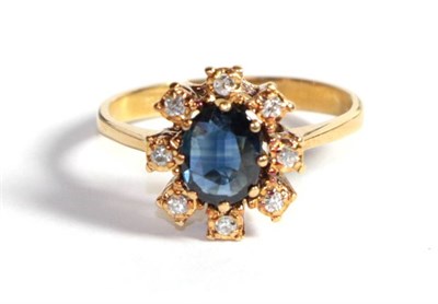 Lot 208 - A sapphire and diamond cluster ring, finger size L1/2