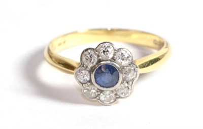 Lot 214 - An 18 carat gold sapphire and diamond cluster ring, total estimated diamond weight 0.40 carat...
