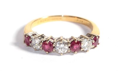 Lot 216 - A ruby and diamond seven stone ring, marks rubbed, finger size L1/2
