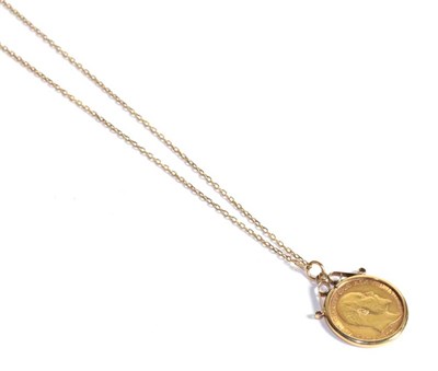 Lot 227 - A 1905 half sovereign loose mounted as a pendant in a 9 carat gold frame on a chain stamped...
