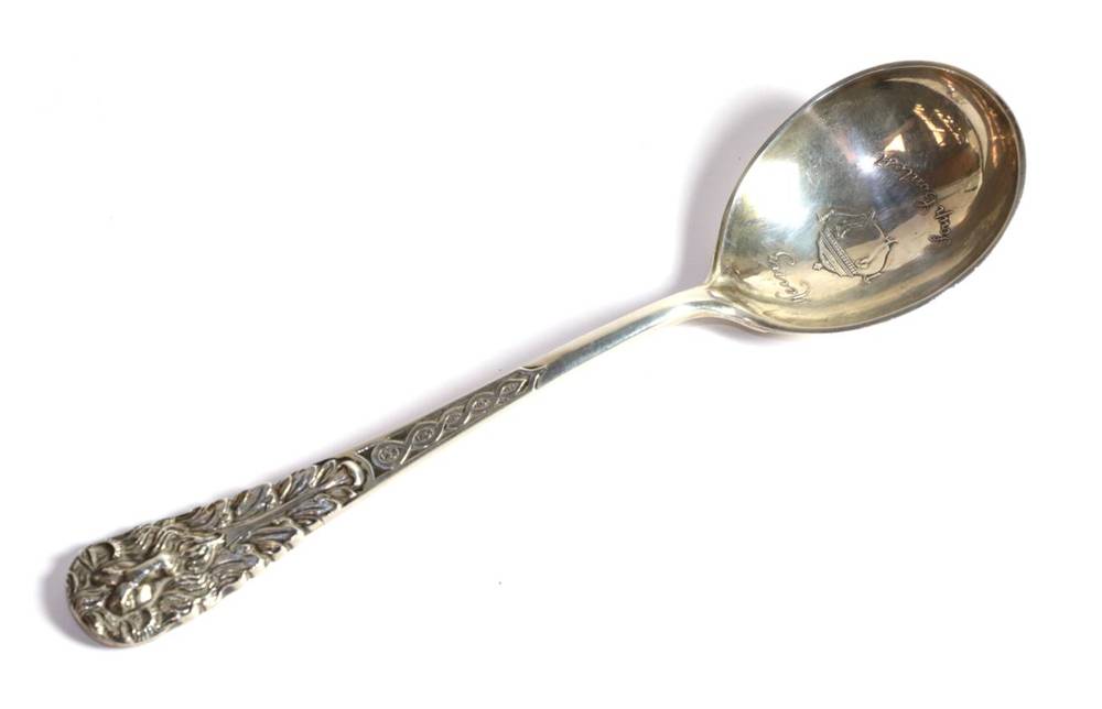Lot 238 - Tiffany & Co, a presentation silver soup spoon or ladle, London 1933, finely decorated with a ram's