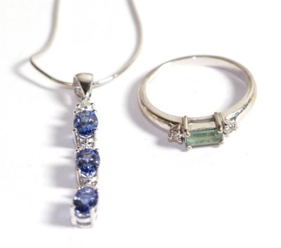 Lot 239 - An 18 carat white gold tanzanite and diamond pendant on an 18 carat white gold chain, chain...