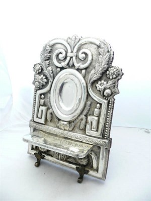 Lot 1030 - A Latin American Silver Plated Missal Stand, of cartouche shape, worked in high relief with a...