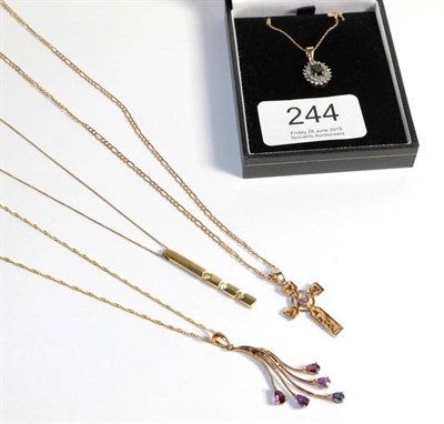 Lot 244 - Four 9 carat gold pendants on chains including a gem set cross, a gem set cluster, a gem set...