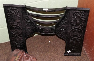 Lot 277 - A Victorian cast iron fire insert and a two man lumberjack saw (2)
