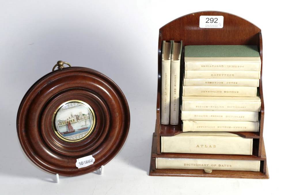 Lot 292 - A mahogany cased ''Reference Library'' of twelve vellum bound books; and a circular miniature...