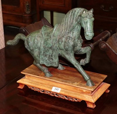 Lot 340 - A bronze Tang style horse on wooden stand