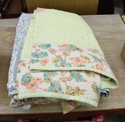 Lot 1151 - Circa 1930s patchwork cover in bright coloured florals, purple and purple floral to reverse;...