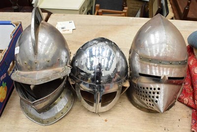 Lot 1154 - Three medieval style steel helmets, comprising a close helmet with high comb, a basinet and a...