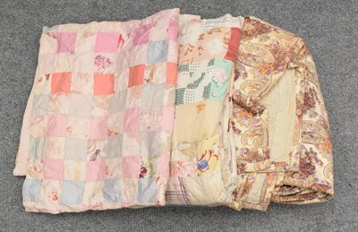 Lot 1163 - Early 20th century quilts and bed covers including a pink and floral 6cm squared patchwork...