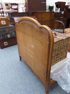 Lot 1174 - A French walnut bergere single bedstead   Purchased from Liberty & Co, London