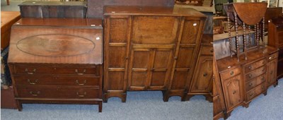 Lot 1183 - A reproduction mahogany bureau; an oak bureau cabinet; a small reproduction sideboard and a...