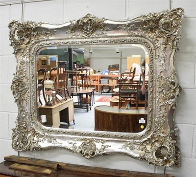 Lot 1191 - A modern silvered ornate mirror