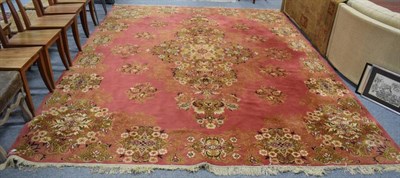 Lot 1214 - A machine made carpet of Oriental design, 300cm high by 386cm