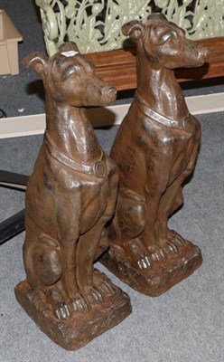 Lot 1219 - A pair of reproduction garden ornaments in the form of seated greyhounds